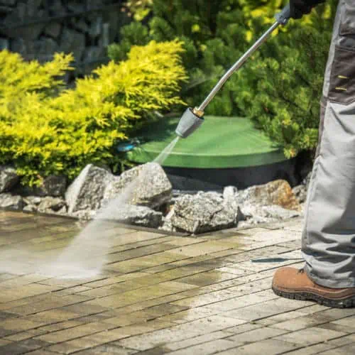 Soft washing a patio before repainting.